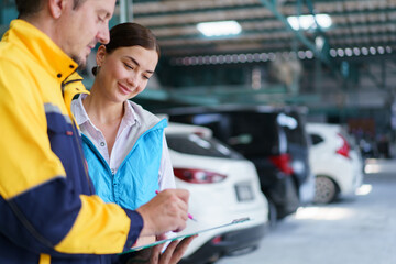Automotive technician let female customer sign a reparing document before returning her repered vehicle.