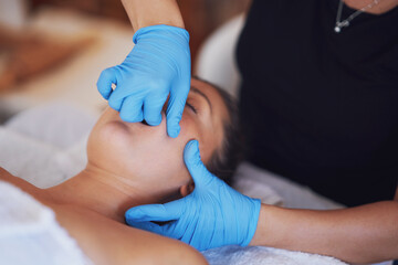 Woman having mouth massage in blue gloves