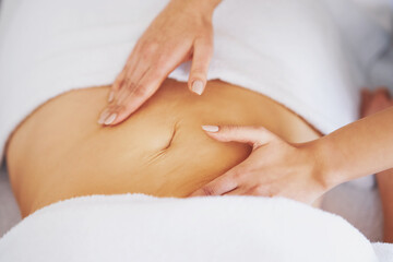 Woman having a belly massage in salon