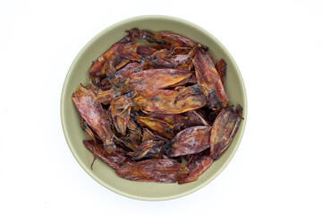 Dried squid in green bowl on white background.