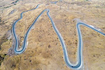 Drone view of hairpin road nearby Vorotan Pass on sunny autumn day. Vayots Dzor Province, Armenia.
