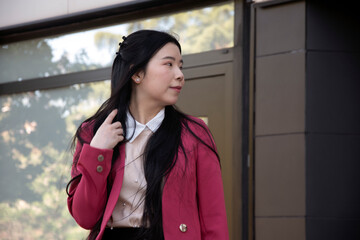 Fototapeta premium Young Chinese woman dressed as a businesswoman