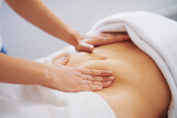 Woman having a belly massage in salon
