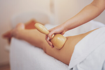 Woman at massage therapy with wooden tools