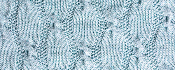 Banner with abstract turquoise cable knitted pattern background texture. Top view of knitting clothes en ball yarn