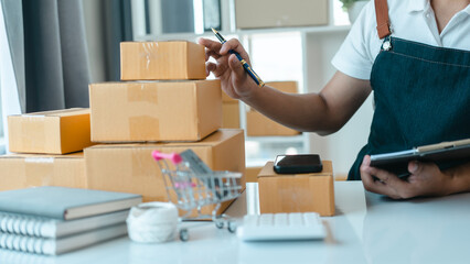 Asian business man seller freelancer prepares box for delivery to  customer in sme supply chain,...