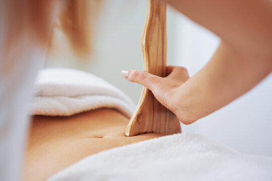 Woman at massage therapy with wooden tools