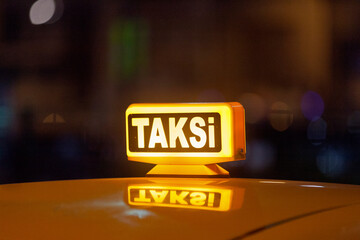 Illuminated yellow Turkish taxi sign - obrazy, fototapety, plakaty
