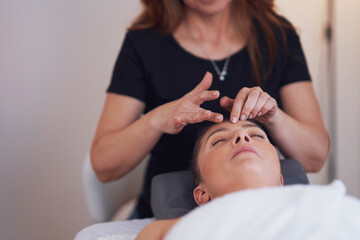 Woman having japan style face massage in salon