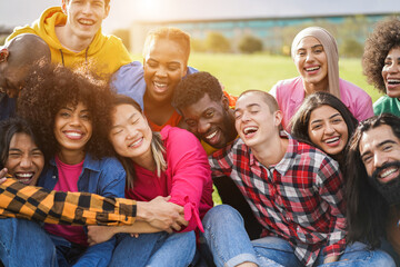 Young diverse people having fun outdoor laughing together - Focus on bald girl face