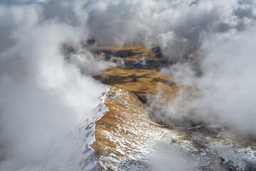 Aragats slope in the clouds on sunny autumn day. Aragatsotn Province, Armenia.