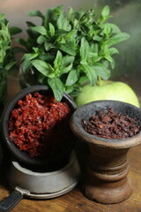 bowl with tobacco for hookah. shisha smoking. berries and fruits on a dark background.