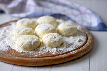 Raw cottage cheese pancakes . Unbaked buns. Ukrainian dish of cottage cheese. 