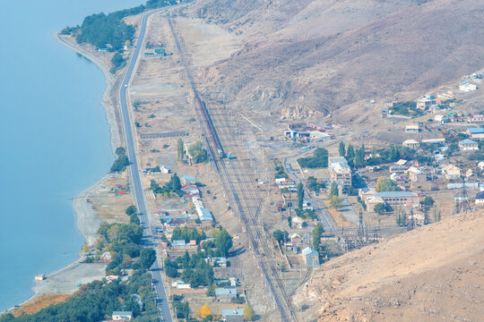 View of Sevan lake, Shorzha village and its train station from Mount Artanish on sunny autumn day. Gegharkunik Province, Armenia.