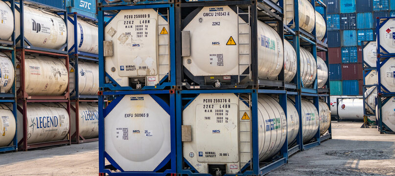 SAMUT PRAKAN, THAILAND-APRIL 16, 2023: Chemical tank container. ISO tank container for chemical delivery. Bulk liquid transport. Chemical company. Container freight area. Global logistics business.