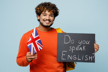 Young Indian boy student wear casual clothes bag hold British flag card with text do you speak...