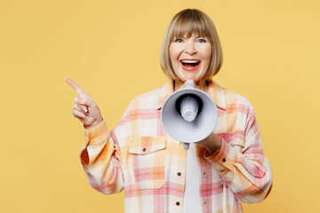 Elderly surprised shocked blonde woman 50s year old wear casual clothes hold in hand megaphone...