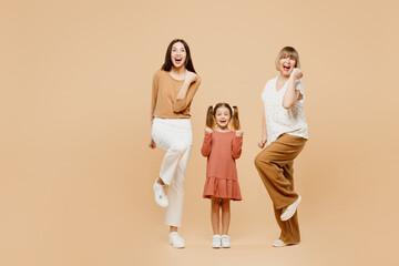 Full body women wearing casual clothes with child kid girl 6-7 years old. Granny mother daughter do...