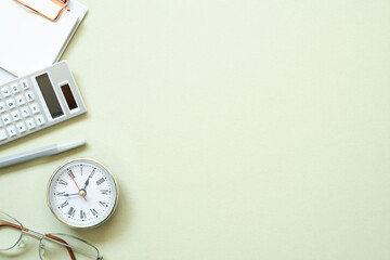 Clipboard, pen, clock, eyeglasses, calculator on mint desk background. study and workspace. flat lay, top view, copy space