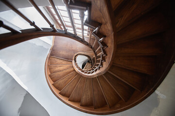 Fototapeta premium Top view of wooden spiral staircase in old church