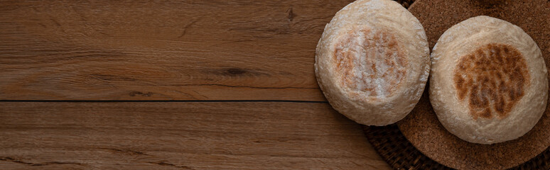 Traditional Portuguese flat circular bread Bolo Do Caco with copy space. Madeira island cuisine. Flat lay