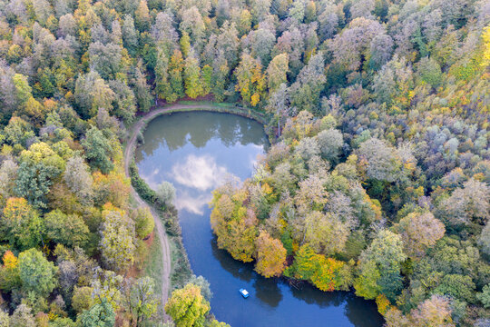 Aerial view of a boat on Parz Lich lake on autumn evening. Dilijan National Park, Tavush Province, Armenia.
