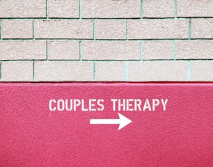 Fototapeta na wymiar Pink wall with sign direction point to COUPLES THERAPY, psychotherapy helping partners improve their relationship by discuss and resolve issues in several aspects
