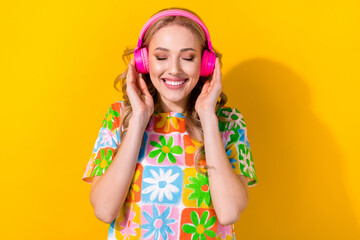Portrait of pleasant adorable woman wear flower print t-shirt hands touching headphones enjoy music...