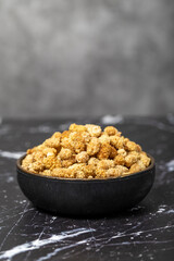 Dried mulberry. Sun-dried organic white dried mulberry in bowl. Superfood, Vegetarian food concept. healthy snacks