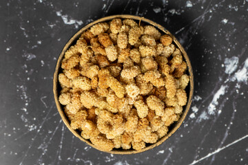Dried mulberry. Sun-dried organic white dried mulberry in bowl. Superfood, Vegetarian food concept. healthy snacks. Top view