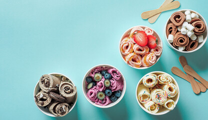 rolled ice creams in cone cups on blue background