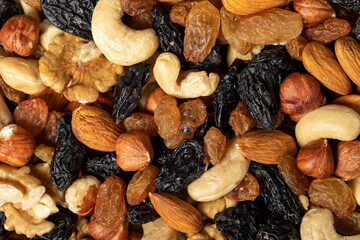 Mixed raw nuts. Special mixed nuts closeup food background. Top view. Mix hazelnut, almond, cashew, pistachio, dried blueberry. texture. copy space banner