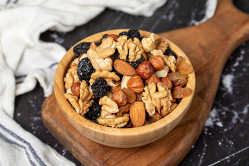 Mixed raw nuts. Special mixed nuts in bowl. Hazelnut, almond, cashew, pistachio, dried blueberry. Superfood. Vegetarian food concept. healthy snacks. Close up