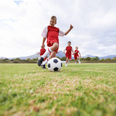 Running, kick and sports with children and soccer ball on field for training, competition and...