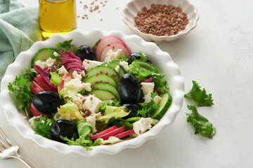 Lettuce salad, cucumber, radish salad with cottage cheese and flax seeds olive oil salad. Healthy diet food. Diet menu and balanced diet. Top view.