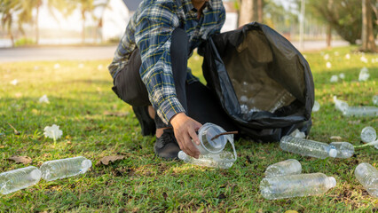 Man collecting plastic bottles, collecting garbage, plastic bottles, taking care of garbage in a national park. Pollution problems. Environmental protection and global warming.