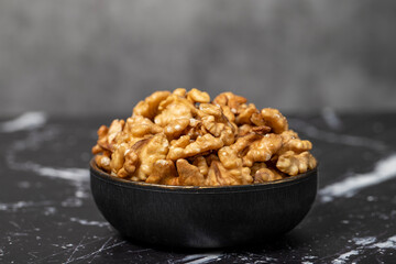 Walnut. Walnut kernel in bowl. Superfood. Vegetarian food concept. Healthy snacks. Close up