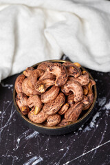 Cashew nuts . Roasted cashew nuts with shell in bowl. Superfood. Vegetarian food concept. Healthy snacks