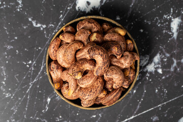 Cashew nuts . Roasted cashew nuts with shell in bowl. Superfood. Vegetarian food concept. Healthy snacks. Top view