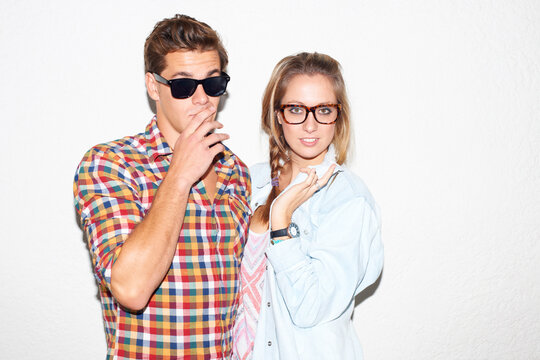 Portrait of cool couple at party, sunglasses on face and gen z fashion with university culture in youth. Nerd students, woman and man in crazy picture at college, hipster people on wall background.