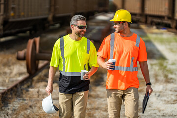 Two construction workers in helmet at building. Construction building. Construction site managers. Workers in helmet on the new building. Two builder with hardhat helmet on construction site.