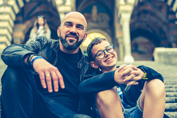Happy smiling beautiful  Tourists   father and son traveling in Italy poses and making photos near...