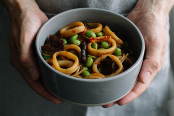 noodles with squid and vegetables close-up
