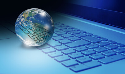 Glass globe on laptop keyboard with many stars "Elements of this image furnished by NASA "