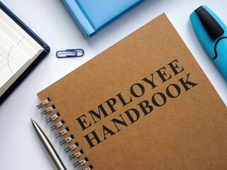 An Employee handbook near notepads and pen. - obrazy, fototapety, plakaty