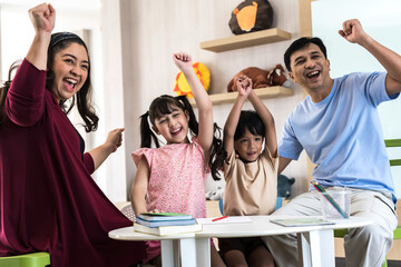 Smiling Asian family feeling happy and raising hands , Family Concept