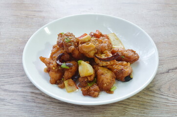 fried crispy chicken with cashew nut and slice onion on plate 