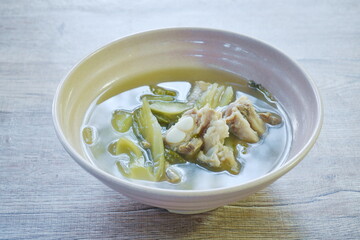 boiled pickled cabbage with pork bone in clear soup on bowl 