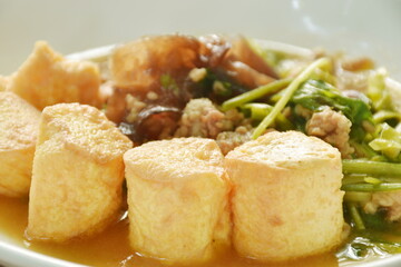 deep fried egg tofu with mashed pork and black ear mushroom with celery on plate