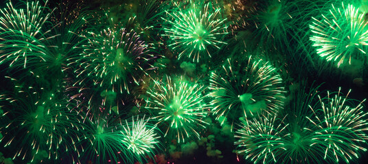 colorful green fireworks on black sky background banner